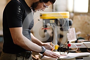 Carpenter engaged in processing wood at the sawmill.