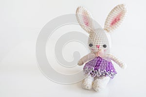 Handmade crochet doll. Cute rabbit doll on white background.