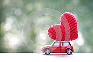 Handmade crochet heart on miniature car for valentine day and wedding card