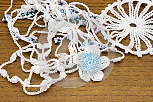 Handmade crochet white chain and a blue flower. Homemade necklace, needlecraft.