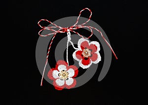 Handmade crocheted flowers with red and white string, known as Martisor.