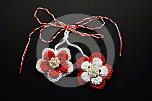 Handmade crocheted flowers with red and white string, known as Martisor.