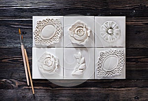 Handmade decor from a plaster relief stucco and a paintbrush for coloring