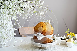 Handmade easter cake with white flowers and decor on table