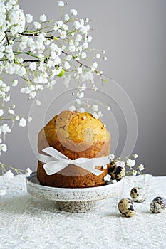 Handmade easter cake with white flowers and decor on table