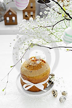 Handmade easter cake with white flowers and decor on table