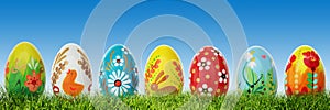 Handmade Easter eggs on grass. Panorama, banner.