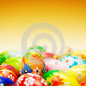 Handmade Easter eggs on yellow background. Spring patterns