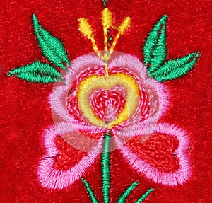 Handmade embroidery flower on red velvet