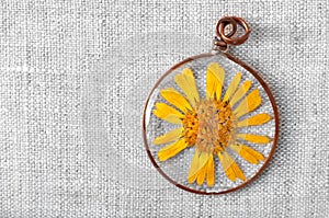 Handmade epoxy resin jewelry. pendant. calendula officinalis flower in copper frame