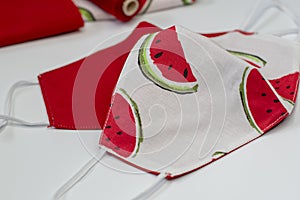 Handmade fabric cotton reversible face masks in white and red with watermeloon pattern. Protection against saliva,