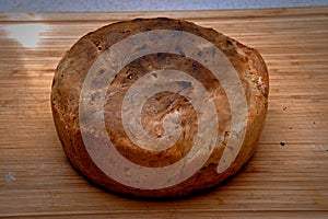 Handmade freshly baked wheat bread on the wooden desk