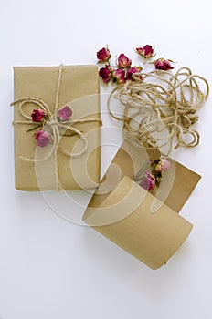 Handmade gift box with craft paper dry roses and ropes