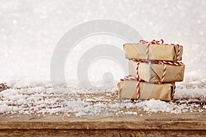 handmade gift boxes over snowy wooden table