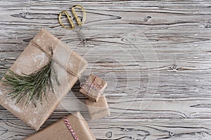 Handmade gifts made from craft paper christmas rope and tree on the rustic wood planks background. DIY