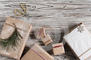 Handmade gifts made from craft paper christmas rope and tree on the rustic wood planks background. DIY