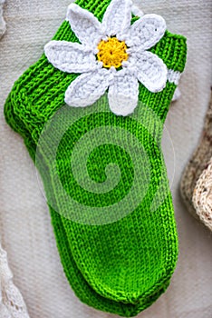 Handmade green wool socks with the white flower