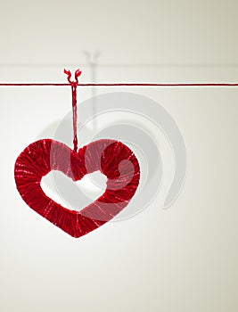 Handmade heart made from red threads