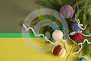 handmade. knitted balls for the Christmas tree, various crocheted Christmas toys, fir branches.