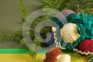 handmade. knitted balls for the Christmas tree, various crocheted Christmas toys, fir branches.