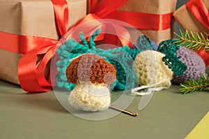 handmade. knitted balls for the Christmas tree, various crocheted Christmas toys, fir branches and gift boxes