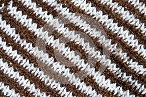 Handmade knitted fabric brown white wool background texture