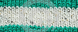 Handmade knitted fabric green and white wool background texture