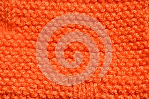 Handmade knitted fabric orange wool background texture