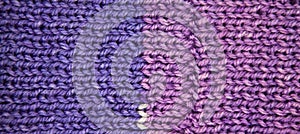 Handmade knitted fabric purple and blue wool background texture