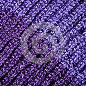 Handmade knitted fabric purple wool background texture