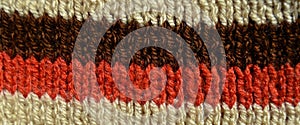 Handmade knitted fabric red brown and beige wool background texture