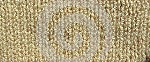 Handmade knitted fabric yellow and beige wool background texture