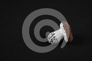 handmade knitted mushrooms isolated on black background