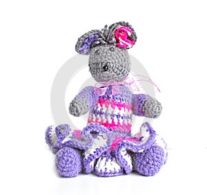 Handmade knitted toy. Amigurumi mouse toy in the hand . Crochet stuffed animals. Isolated background