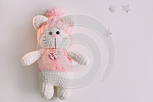 Handmade knitted toy cat on white. Hello kitty. flat lay, top view