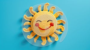 Handmade knitted toy smiling sun on blue background. Top view