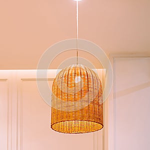 Handmade Lamp Wicker..Vintage Style Room Design. Interior of hanging Lamp illuminated, ceiling light lamp covered with weave.