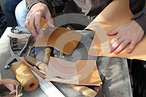 Handmade leather goods, craftsman at work in a workshop