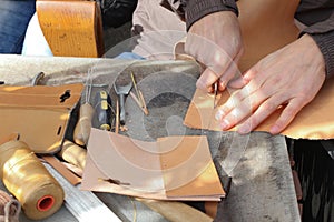 Handmade leather goods, craftsman at work in a workshop