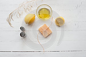 Handmade lemon soap, lemons and olive oil top view