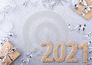 Handmade lettering 2021 and craft Christmas gifts on a silver background with a ribbon