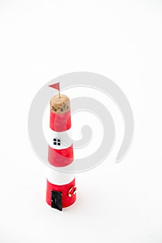 Handmade lighthouse from colored paper. Handicraft and hobby concept. Object on a white background