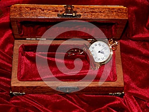 A handmade mahogany casket with watches and diamonds on velvet