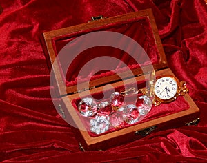 A handmade mahogany casket with watches and diamonds on velvet