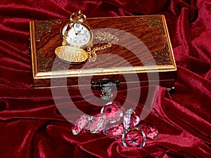 A handmade mahogany casket with watches and diamonds on velvet