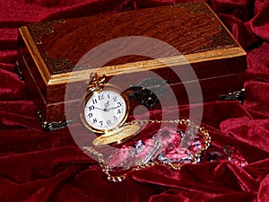 A handmade mahogany casket with watches and diamonds on velvet