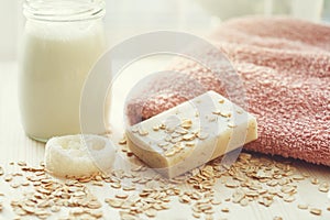 Handmade milk and honey soap bar, soft towel, luffa, oat flakes and bottle of milk shampoo