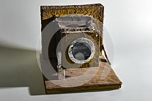 handmade model of an old box camera made of wood, cardboard and foil