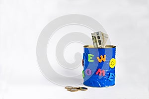 Handmade money box with New home inscription, Euro banknotes and some coins. white background