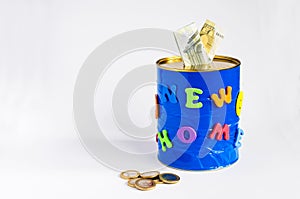 Handmade money box with New home inscription, Euro banknotes and some coins. white background